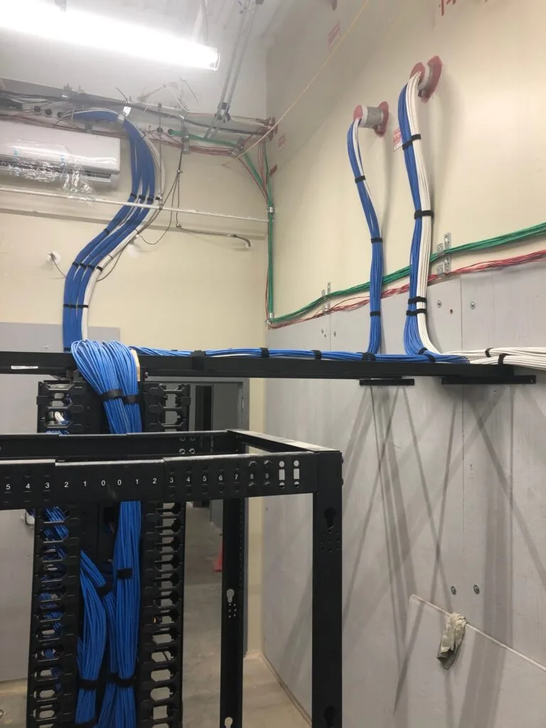 Server room cable management with blue Cat6 cabling